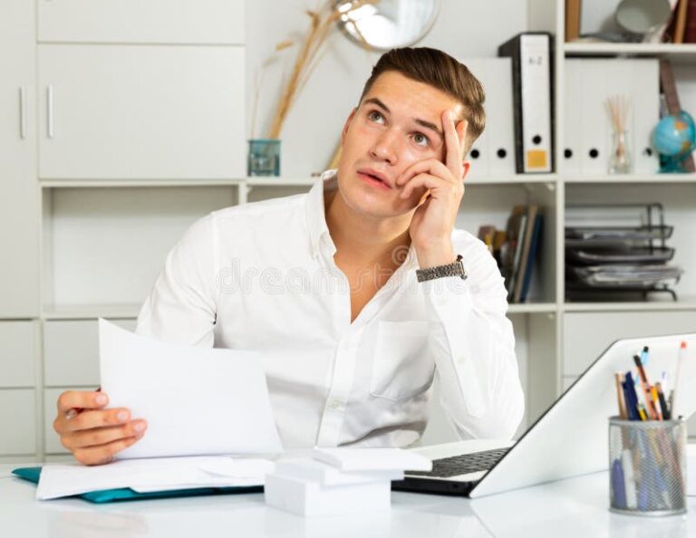 un salarie perplexe devant un bureau