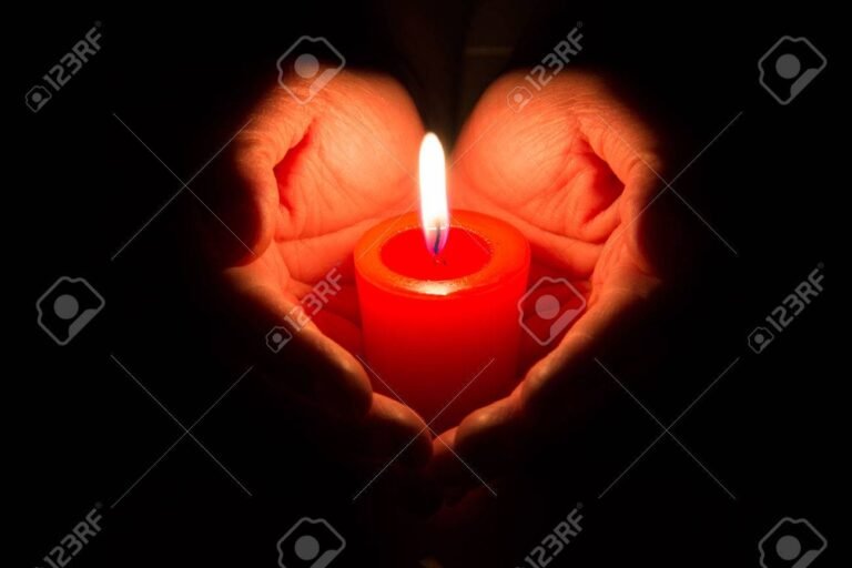 une main tenant une bougie allumee